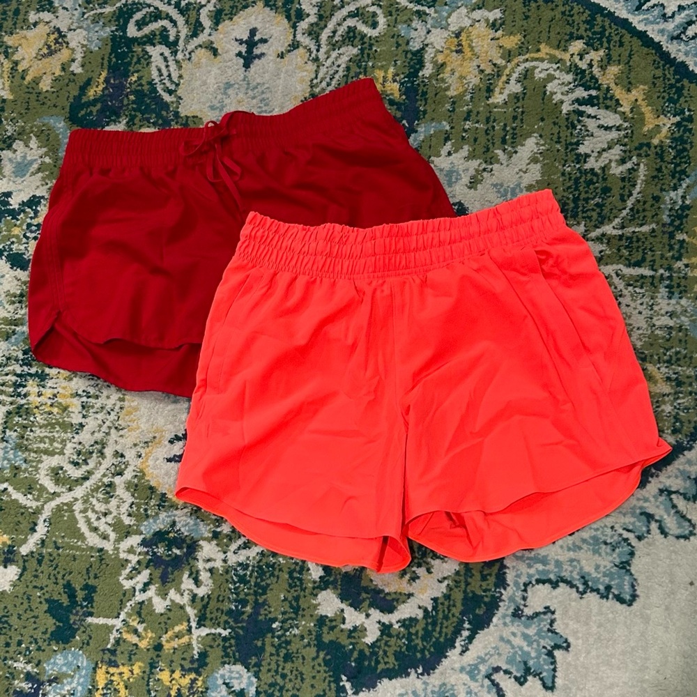 2 women size Medium running athletic shorts red neon orange Under Armour
